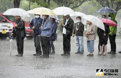 熊本發生強震至今已知48人喪命，南阿蘇村有2人下落不明，搜救工作21日因雨暫停。大津町民眾在大雨中排隊領取中餐。（共同社提供）中央社　105年4月21日