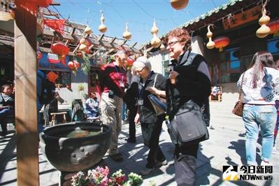 外國遊客參觀完四合院後，在胡同內搭乘人力三輪車離開，繼續游胡同、感受傳統風情。