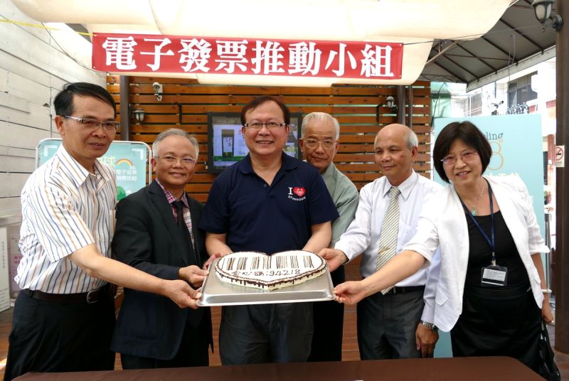 財政部財政資訊中心主任蘇俊榮〈中〉、18度C文化基金會執行長王又興(左2)與貴賓共為巧克力工房特製的愛心條碼蛋糕揭幕。