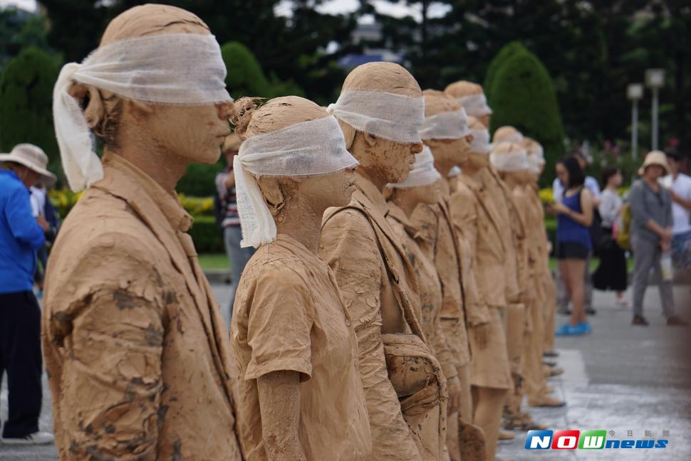 自由廣場8日下午出現一群行動藝術表演團體，在場廣場內緩慢移動，一度遭誤以為是抗議團體，引發騷動。（圖／記者呂炯昌攝 , 2017.7.8）