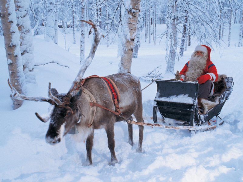 Santa Claus riding on sleigh, Lapland, Finland