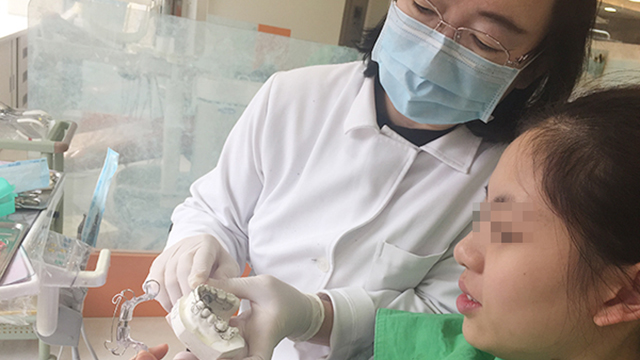 ▲宋慧玲醫師指導女童正確使用日式不拔牙矯正擴張器。（圖／公關照片）