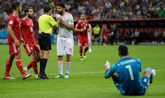 ▲伊朗守門員Alireza Beiranvand被西班牙前鋒Diego Costa踩腳後痛倒在地。（圖／美聯社／達志影像）