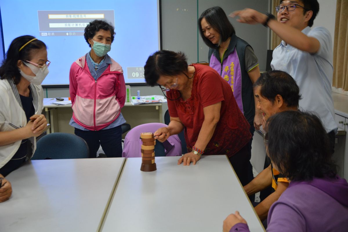 專業的職能治療師教長輩一起玩桌遊。（圖／記者郭政隆攝影2018.9.5）