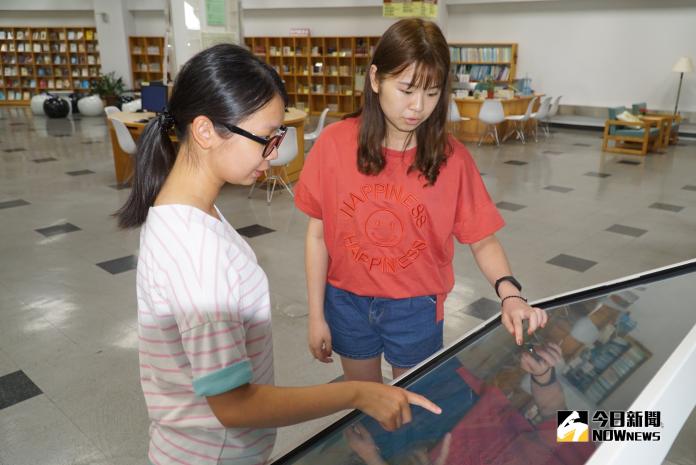 大葉大學圖書館購置電子書閱讀導覽機，是台灣中部第一所導入新創閱讀服務的大學，學生一邊操作圖書館電子書閱讀導覽機，一邊討論報告。（圖／記者陳雅芳攝，2018.09.14)