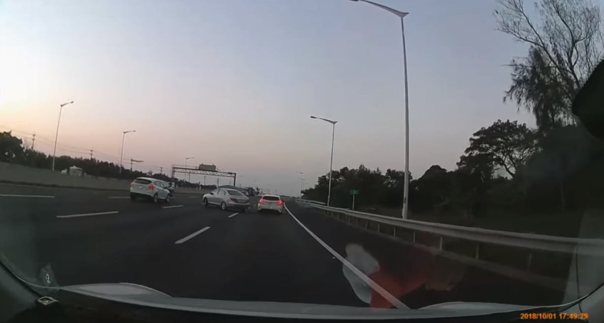 ▲兩輛自小客疑似因為行車糾紛，不斷的在2號國道往大園方向的外側車道逼車糾纏，造成後方的車輛也必須放慢車速，小心地繞道前進。（圖／翻攝自「爆料公社」, 2018.10.02）