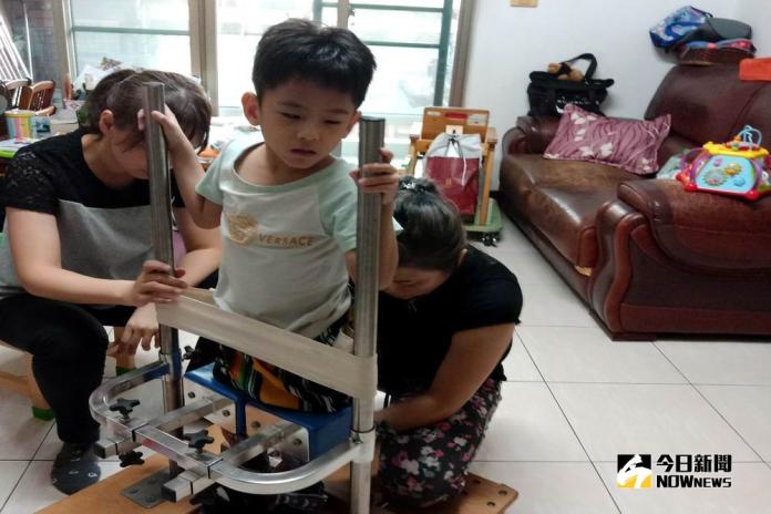 ▲治療師告訴媽媽站立架該如何因應小杰當下的狀況而進行調整。 （圖／記者許高祥攝，2018.10.25）