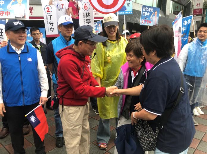 國民黨台北市長候選人丁守中19日一早冒著雨在路口拜票。（圖／丁守中辦公室提供）