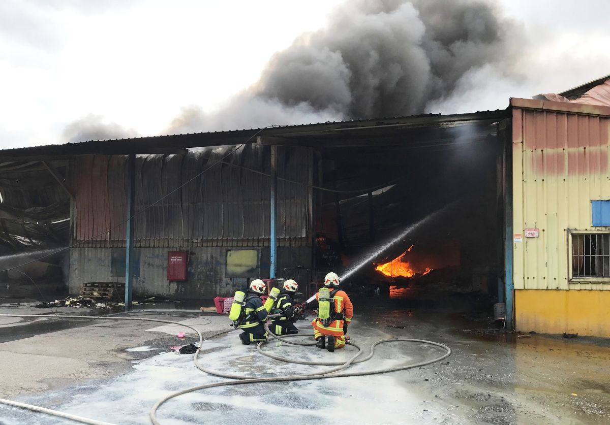 ▲龜山這處鐵皮屋內堆放的多是易燃的布料以及塑膠原料粒，火勢迅速將整個廠房吞噬，濃煙竄天。（圖／桃園市消防局提供）