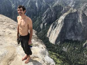 Alex Honnold holds all of his climbing gear atop the summit of El Capitan. He just became the first person to climb El Capitan without a rope. (National Geographic/Jimmy Chin)