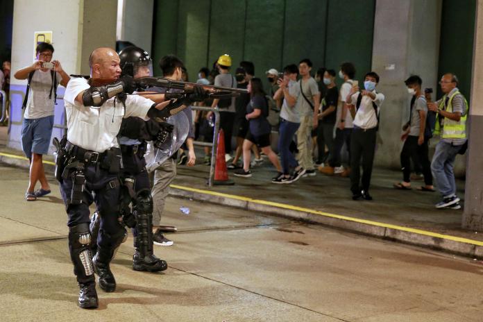 ▲香港光頭警長劉Sir在清場時，近距離掏出長槍、手扣板機、瞄準民眾，引發極大爭議。（圖／美聯社／達志影像）