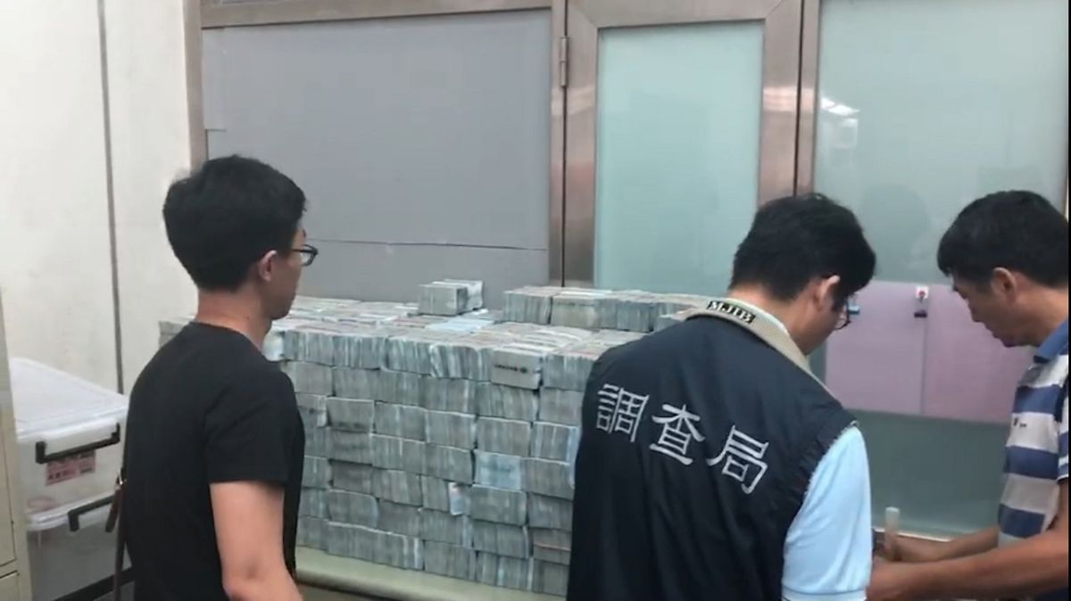 ▲調查局幹員查扣現金，忙著清點鈔票。（圖／記者陳惲朋翻攝）