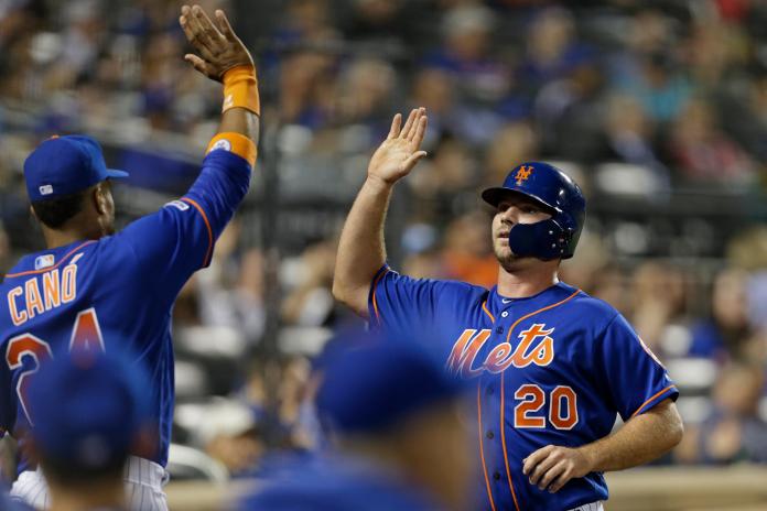 New York Mets' Pete Alonso (20) celebrates scoring a run with Robinson Cano during the third inning of a baseball game against the Atlanta Braves on Friday, Sept. 27, 2019, in New York. (AP Photo/Adam Hunger)
