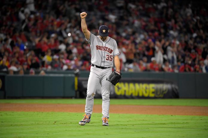 Houston Astros' Justin Verlander, center, celebrates after completing 300 season strikeouts during the sixth inning of a baseball game against the Los Angeles Angels Saturday, Sept. 28, 2019, in Anaheim, Calif. (AP Photo/Mark J. Terrill)