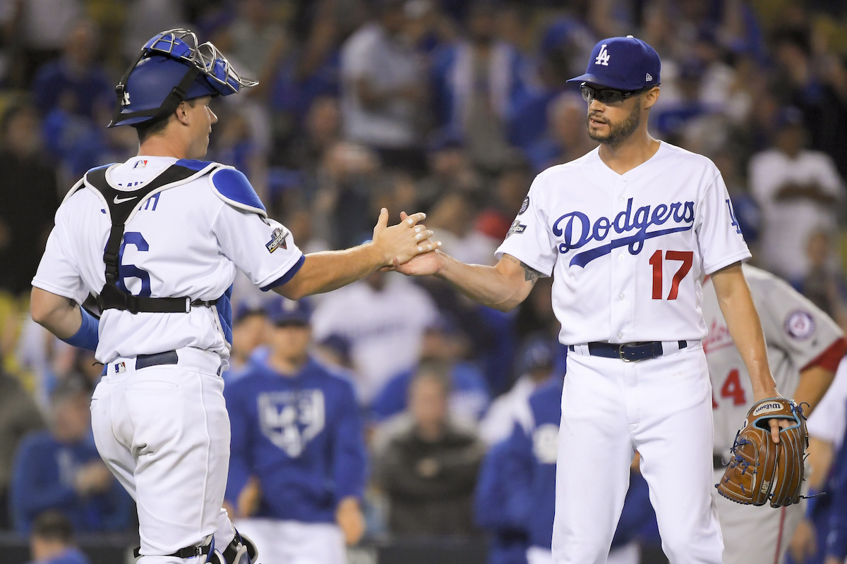 Los Angeles Dodgers catcher Will Smith, left, and relief pitcher Joe Kelly celebrate the team's 6-0 win over the Washington Nationals in Game 1 in baseball's National League Divisional Series on Thursday, Oct. 3, 2019, in Los Angeles. (AP Photo/Mark J. Terrill)