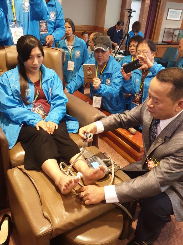 ▲腳底按摩在台灣盛行30年，隨著科技進步，產業追求e化提升競爭力，圖為新開發雷射足療儀器，由理事長闕志安示範講解。（圖／金武鳳攝，2019.12.16)