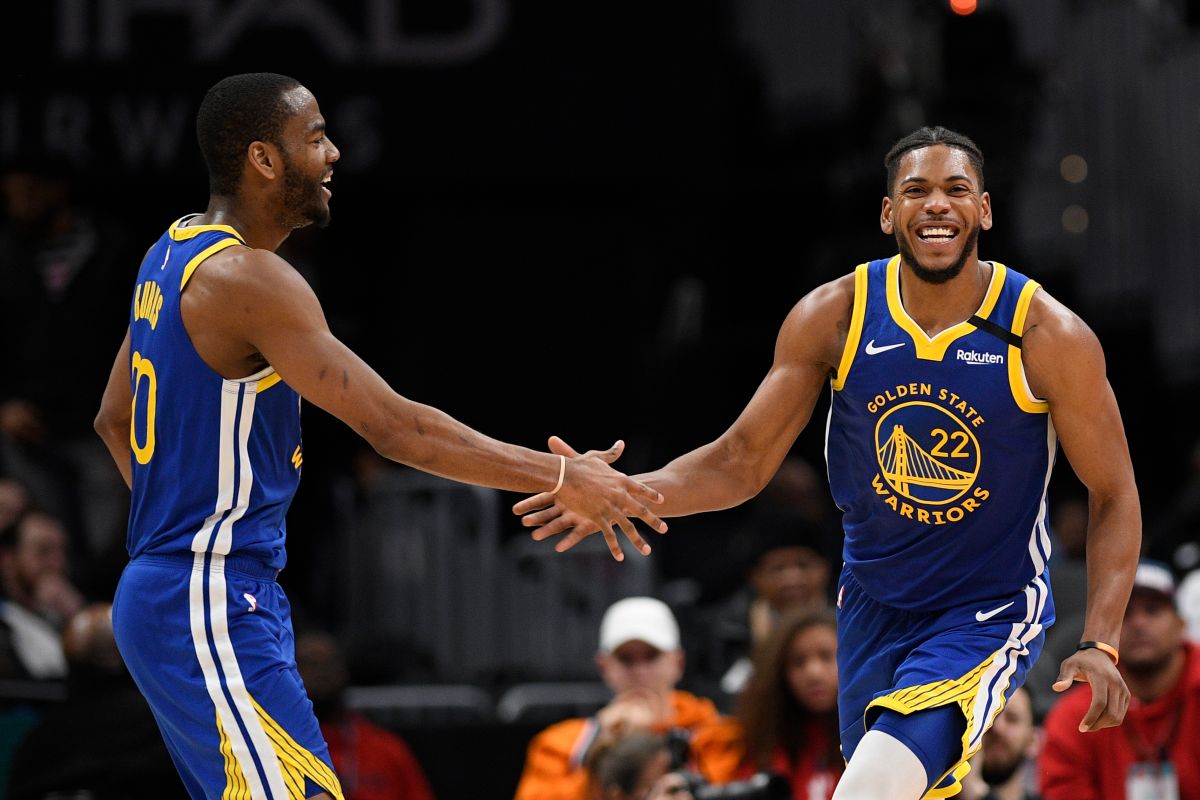 Golden State Warriors forward Glenn Robinson III (22) reacts with guard Alec Burks (20) during the second half of an NBA basketball game against the Washington Wizards, Monday, Feb. 3, 2020, in Washington. The Warriors won 125-117. (AP Photo/Nick Wass)