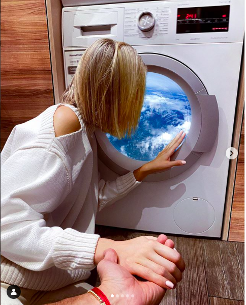 ▲Nataly looking through the washing machine at home (Screengrab from Murad Osmann’s Instagram)