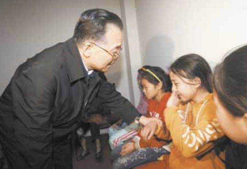 ▲溫家寶安慰汶川地震孤兒。(圖/翻攝自新華網)
