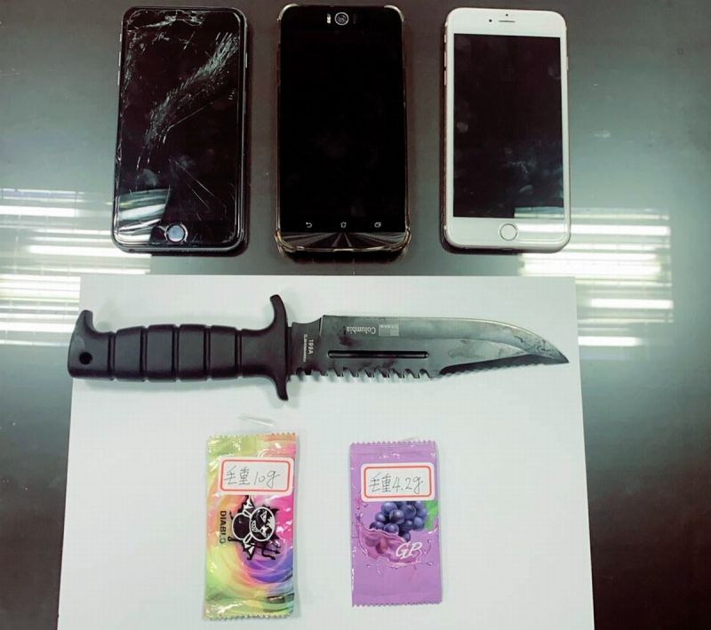 ▲警方現場勘查在路中有發現一把短刀,同時附帶搜索吳男所駕車輛及身體發現車內有咖啡包毒品2包與行動電話。(圖/記者黃正忠翻攝)