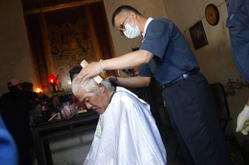 ▲慈濟志工為林阿福修剪頭髮、洗頭、沐浴。（圖／記者葉靜美攝）