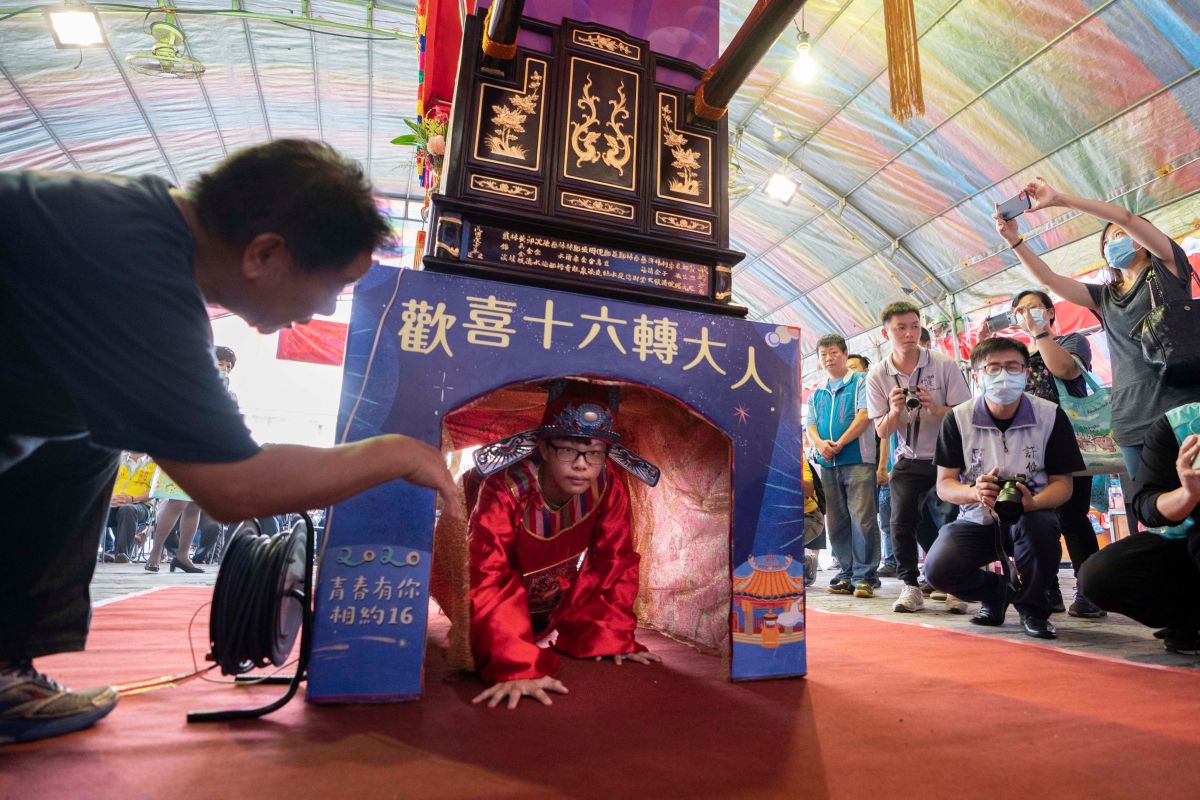 ▲新竹市政府和竹蓮寺於農曆七夕當天，將舉辦成年禮「做十六歲」，市長林智堅與竹蓮寺主委許修睿十一日為2名16歲的高中生行傳統成年禮，透過輭轎腳和脫絭，飲成年酒，象徵長大成人。（圖/記者金祐妤攝,109.8.11）