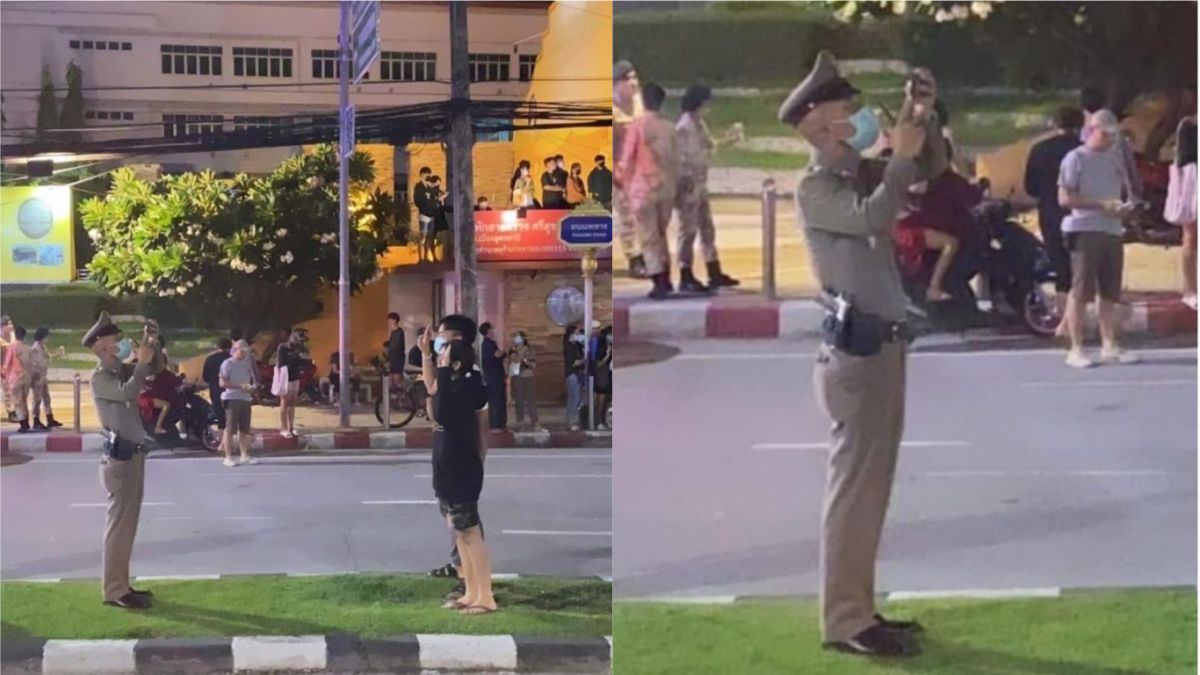 ▲泰國曼谷反政府運動持續，一名泰國警察替年輕的示威情侶高舉3指禮的畫面合影，吸引超過26萬人按讚分享（圖／翻攝自推特@morerainhere）