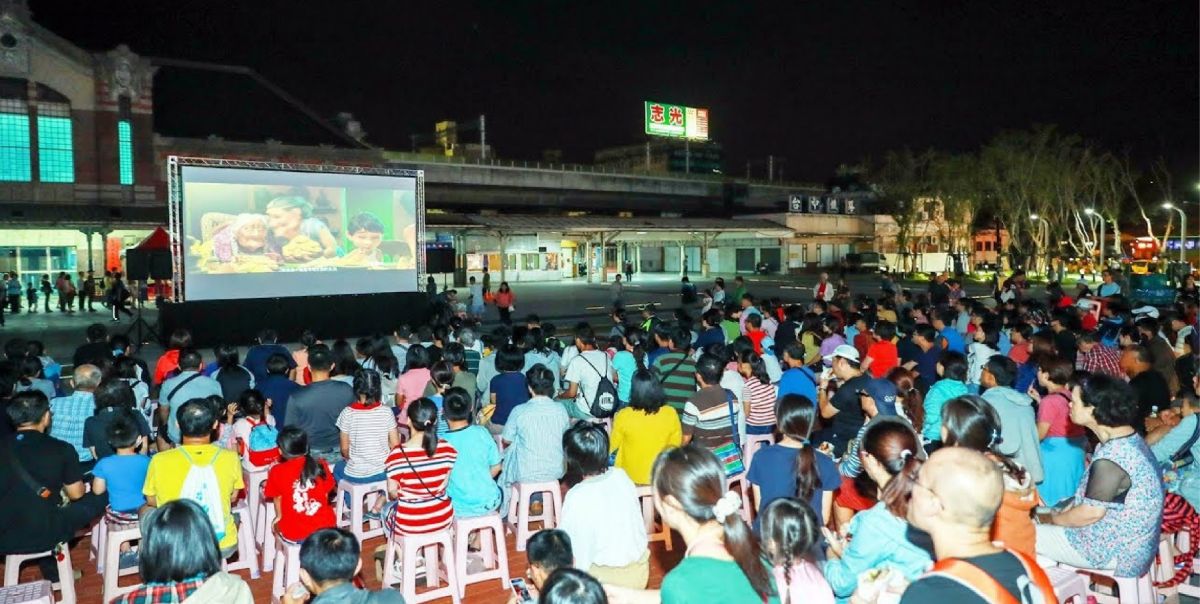 ▲耶誕前夕，台中市政府新聞局舉辦「露天電影放映活動」，在舊台中火車站前搭建400吋大螢幕電視牆，圖為2018年台中火車站前露天電影放映。(圖／新聞局提供2020.12.1)