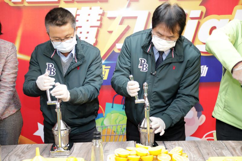 ▲黃偉哲(右)賣力親榨柳丁汁。左為農糧署副署長姚志旺(圖/記者林怡孜攝,2020,12,31)