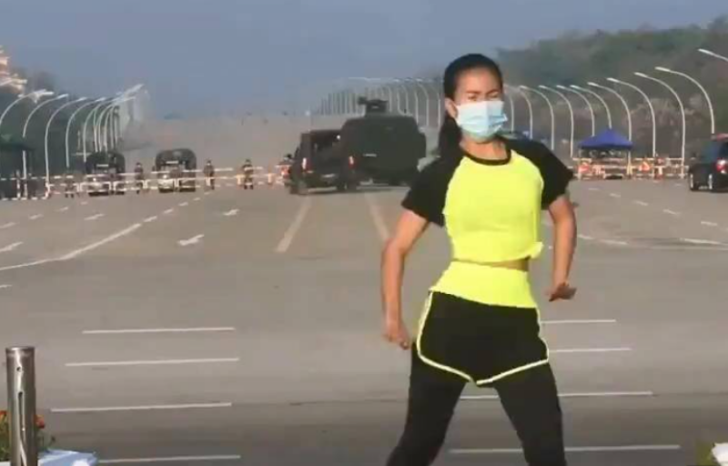 ▲緬甸一名女子因為在政變當天，於首都街頭拍攝健身舞片段時，意外直擊身後軍事卡車、警車駛入國會的畫面，而在網路上爆紅。（圖／截取自影片）