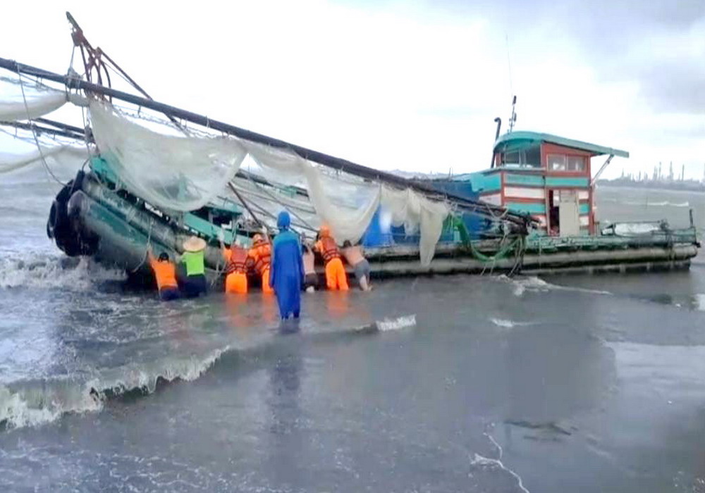 ▲海巡署第五岸巡隊與民眾協力救援擱淺高屏溪出海口的漁筏脫困。(圖／記者黃守作攝，2021.06.15)