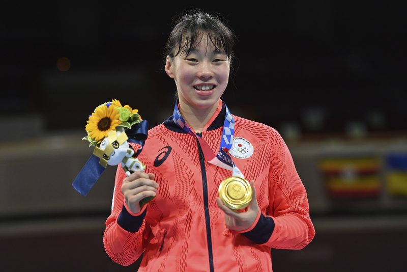 Japan’s Sena Irie stands with her Gold Medal after defeating the Philippines’s Nesthy Petecio, in a women’s featherweight 60-kg final boxing match at the 2020 Summer Olympics, Tuesday, Aug. 3, 2021, in Tokyo, Japan. (AP Photo/Luis ROBAYO, Pool)