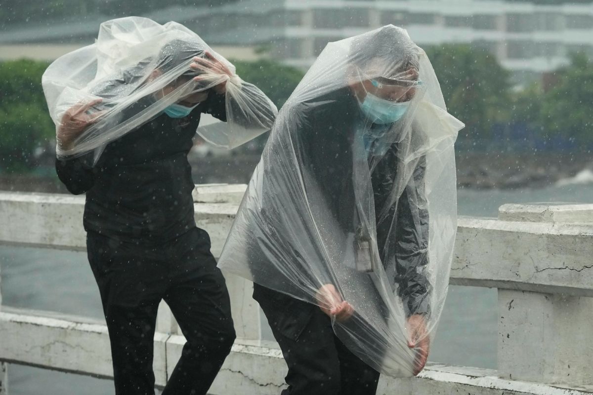 ▲菲律賓接連遭受康森及璨樹2個秋颱襲擊。圖為8日在馬尼拉街頭抵禦強風的路人。（圖／美聯社／達志影像）