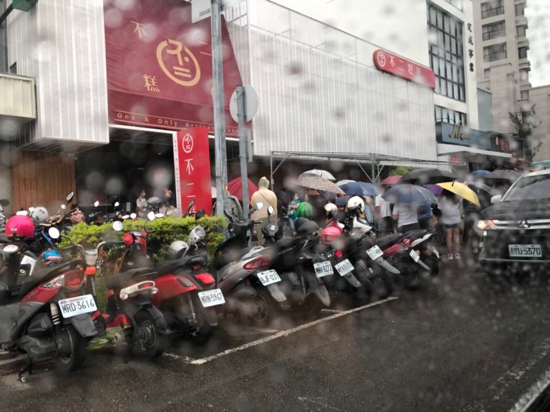 ▲台中「不二糕餅蛋黃酥」下午2點才開放現場購買,下雨天現場竟己大排長龍,影響周邊交通,第四警分局黎明派出所依法到場勸導(圖/柳榮俊攝2021.9.12)