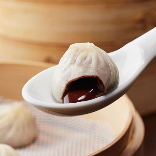 A spoon carries a Chocolate Xiao Long Bao. (Instagram, Din Tai Fung Japan)