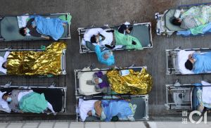 香港疫情 ▲香港疫情爆發,病床數不足,10多名長者躺在帳篷外的病床上,部份人獲發棉被保暖,亦有人需蓋上保暖鋁紙。(圖/翻攝自《香港01》)