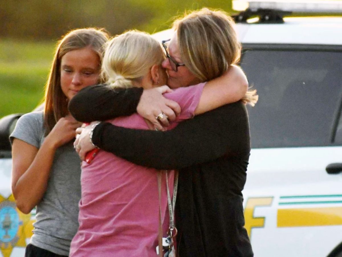 ▲一名男子2日在愛荷華州的教堂停車場槍殺2名女子，然後舉槍自盡。圖為現場悲慟的家屬。（圖／翻攝自NPR）