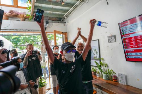 ▲泰國大麻合法化法案今（9）日生效，圖為曼谷「大麻咖啡館」第一名顧客在首日購買合法大麻後慶祝的模樣。（圖／美聯社）