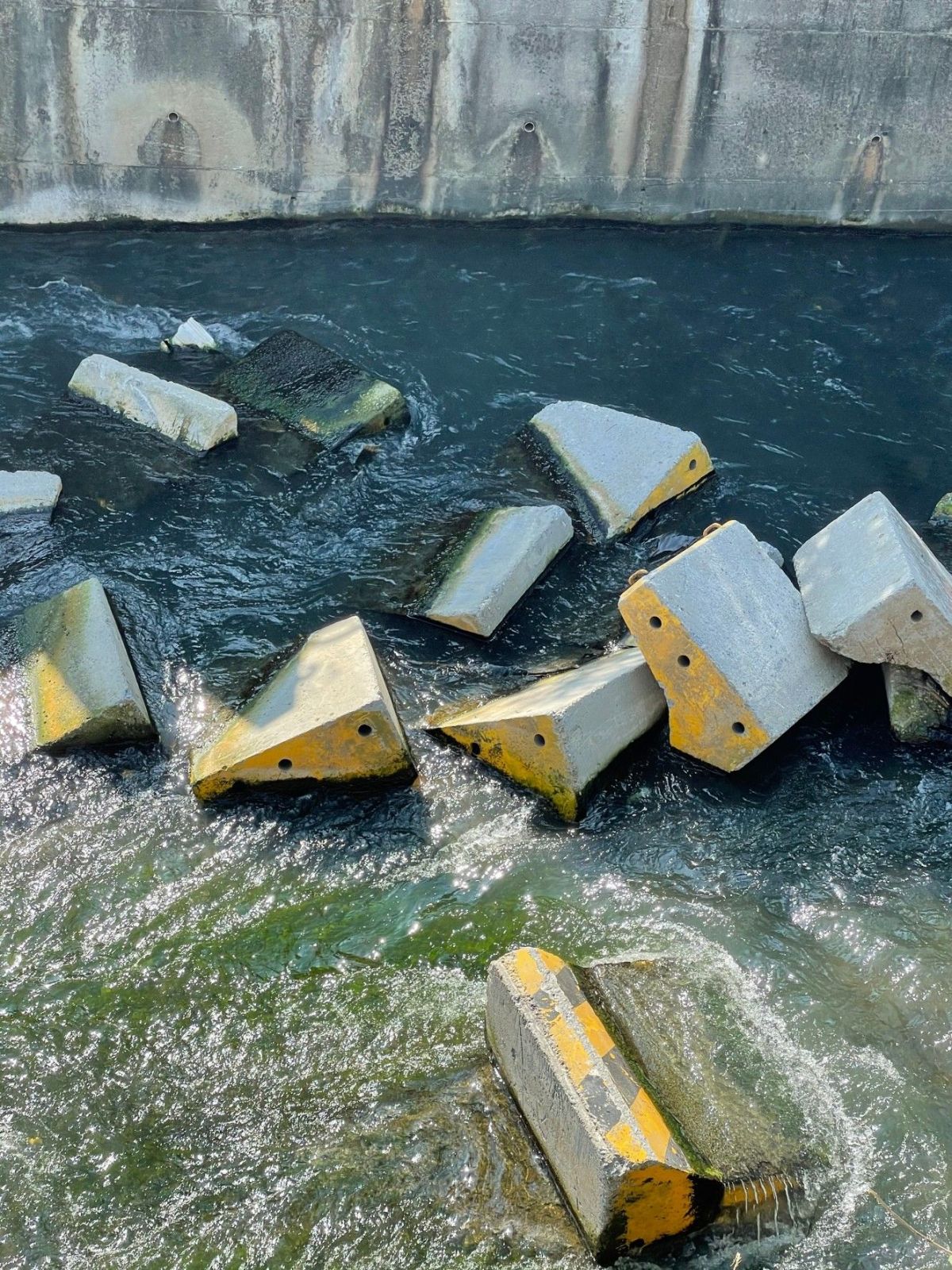 ▲議員何文海質疑中市府沒有監督施工廠商，將數十塊的紐澤西護欄散落在南屯溪中(圖／何文海提供2022.7.15)