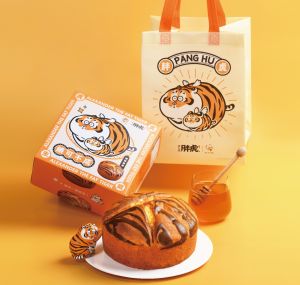 ▲春上布丁蛋糕推出「我不是胖虎」蜂蜜蛋糕，除了搭配聯名包裝盒，買2顆蛋糕送胖虎環保提袋。（圖／業者提供）