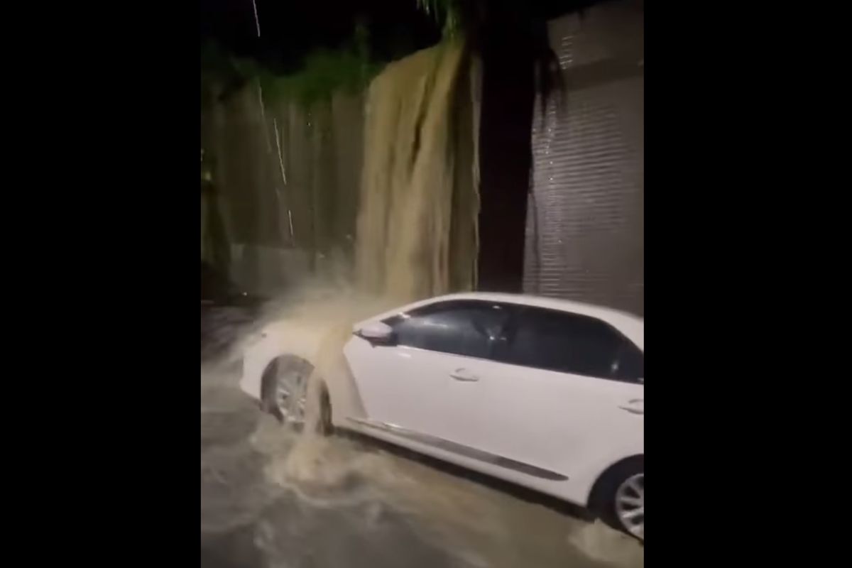 ▲一輛白色轎車停在百齡橋附近路邊，整夜遭到黃色泥水沖刷，讓網友驚呼根本成為另類泡水車。（圖／翻攝自爆廢公社臉書）