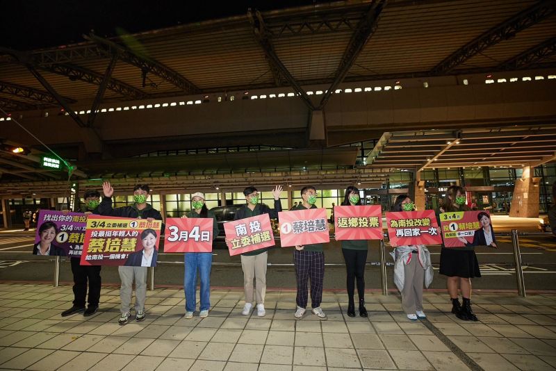 ▲民進黨青年於台中高鐵站外舉起看板，呼籲南投青年為了家鄉改變再返鄉一次、支持蔡培慧。（圖／民進黨提供）