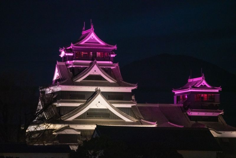 ▲熊本為了歡迎高雄府會訪團，特地在7日、8日晚間在熊本城打上高雄「彩帶高」的「金黃色、桃紅色、綠色、藍色」，見證彼此友好情誼。(圖／高市府提供)
