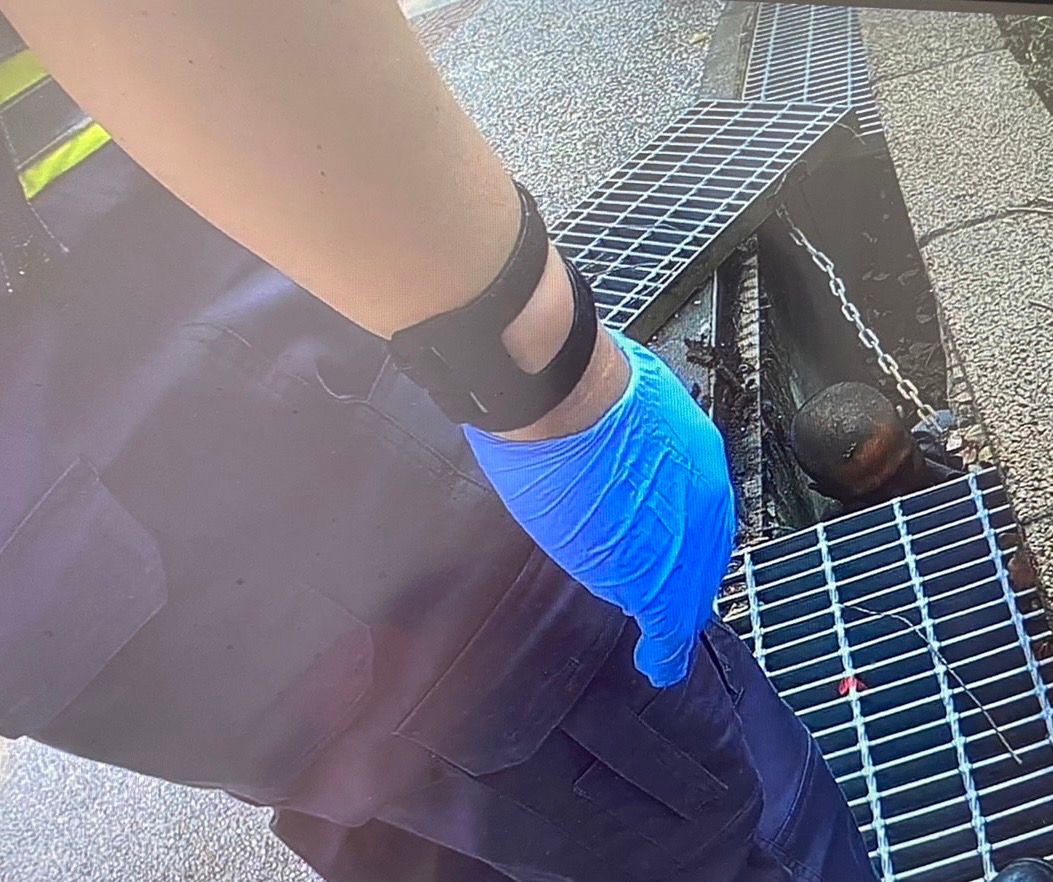 ▲本（4）月10日上午，新北市三重某國小突然有名男子，突然翻牆進入校園內，被老師發現立即通報轄區警員，豈料隔天早自習時間，有學童在中庭驚見「水溝底下有人」，警方獲報趕赴校園，結果發現是同名男子所為，立即將他強制送醫。（圖／翻攝畫面）