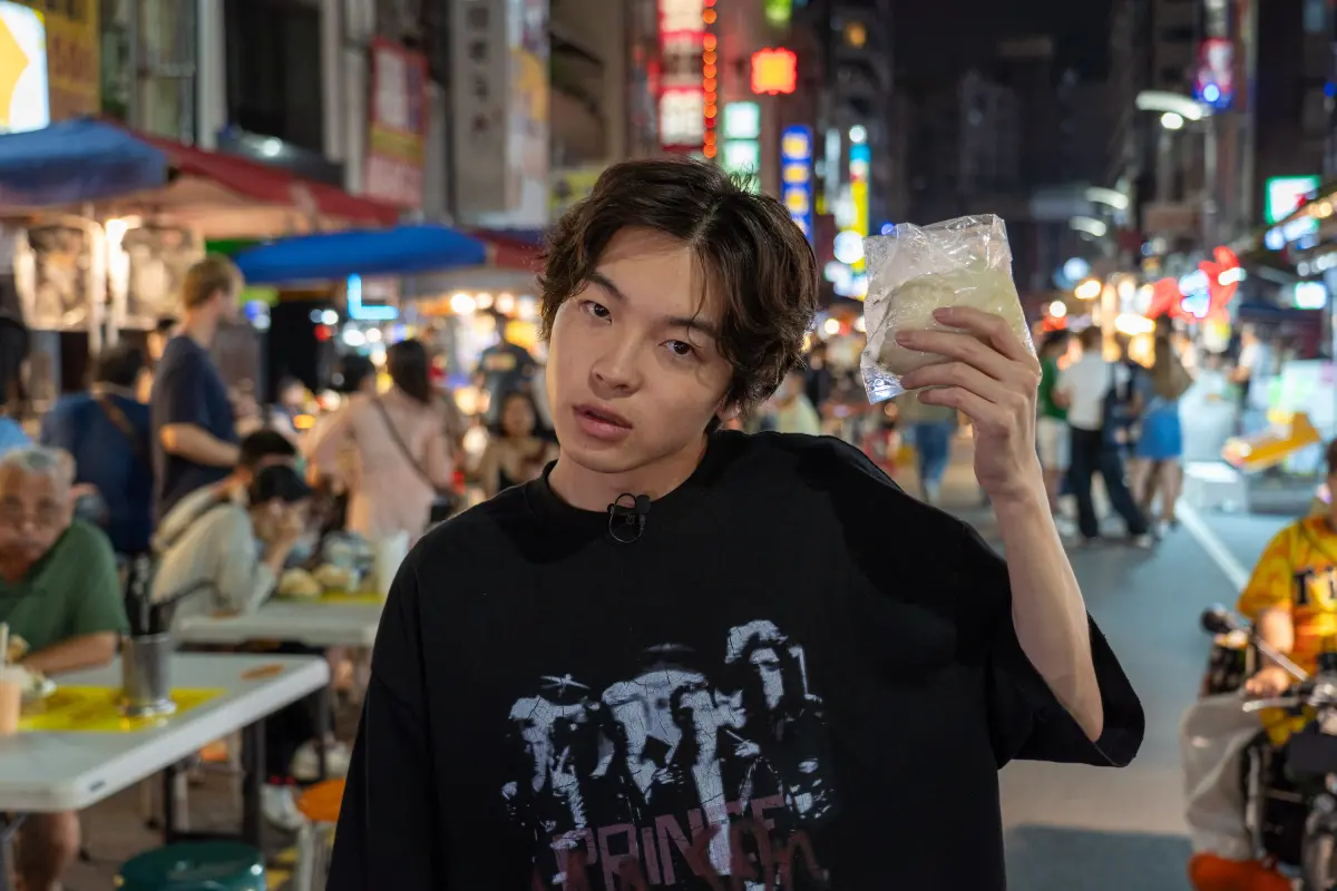 ▲以〈NIGHT DANCER〉一曲爆紅的日本創作歌手 imase大啖六合夜市知名小吃。（圖／高雄市經發局提供）