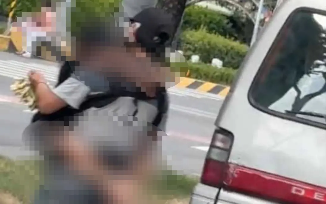 ▲新北市三重一名男子抱著小女孩，穿梭在路口販售玉蘭花，經新北社會局調查，男子抱著的孩子，其實是10歲小男孩戴假髮假扮，而男子本身是常在五股地區出沒的「玉蘭花家族」。（圖／民眾提供）