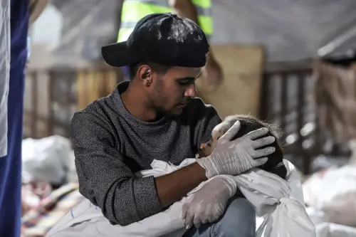 ▲巴勒斯坦加薩的阿赫利阿拉比醫院，當地時間17日遭遇空襲，圖為1名巴勒斯坦男子抱著死去的孩子。（圖／美聯社／達志影像）