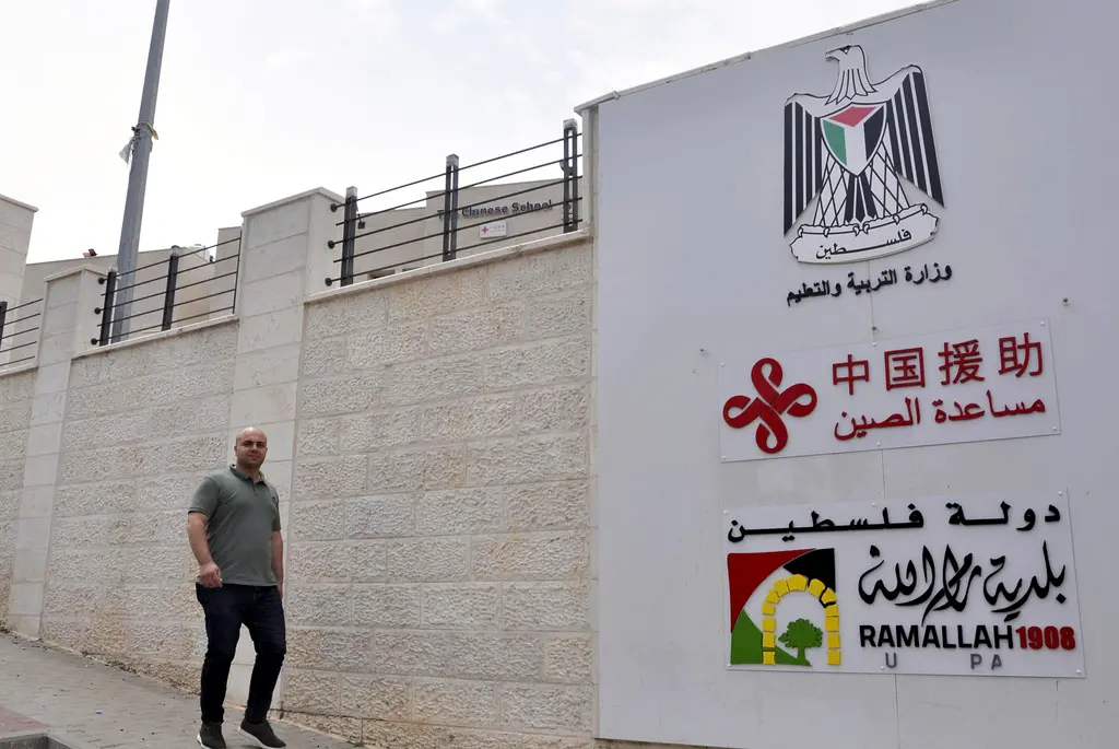 ▲以巴衝突延燒，中國境內輿論幾乎一面倒支持巴勒斯坦人的情緒，也激化反以色列與對猶太人的仇恨。圖為巴勒斯坦一所小學的牆上寫著「中國援助」。（圖／美聯社）