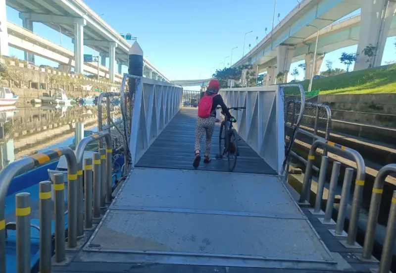 ▲台北港護城河浮動牽引道修復完成串起環島自行車動線。（圖 ／新北市政府高灘地工程管理處提供）