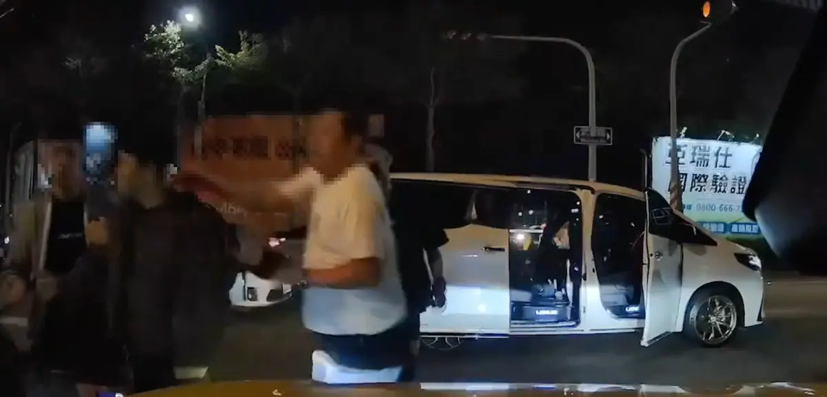▲昨天台南一名男子準備通過閃紅燈路口，當時有不少車從他面前經過，其中一輛Lexus LM更差點撞上他，男子當下氣得出腳怒踹，豈料沒過多久車上有數名惡煞下車，向男子追了上去，並將男子拖到路旁理論（圖／翻攝記者爆料網）